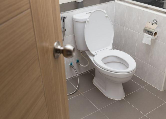 White flush toilet in modern bathroom interior 