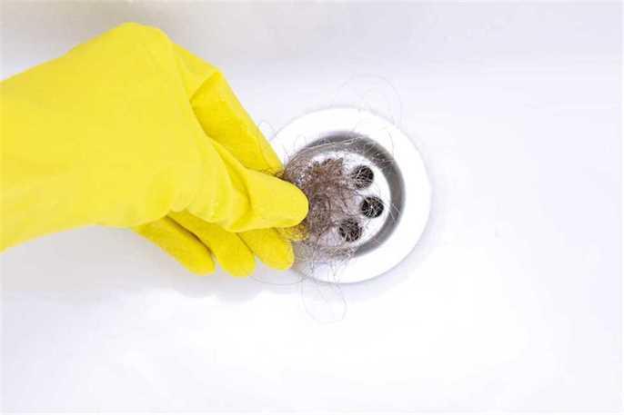 pulling hair from a clogged drain