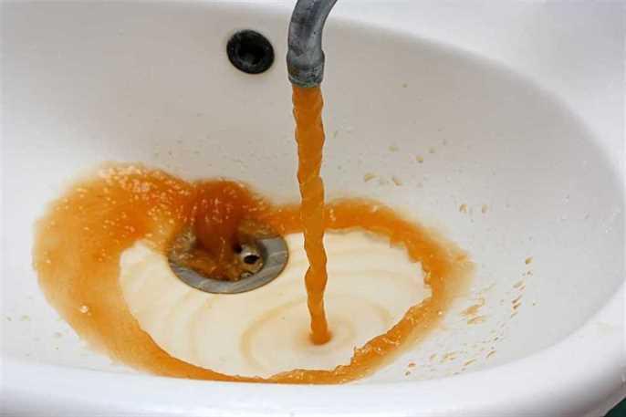 brown water running from a sink tap